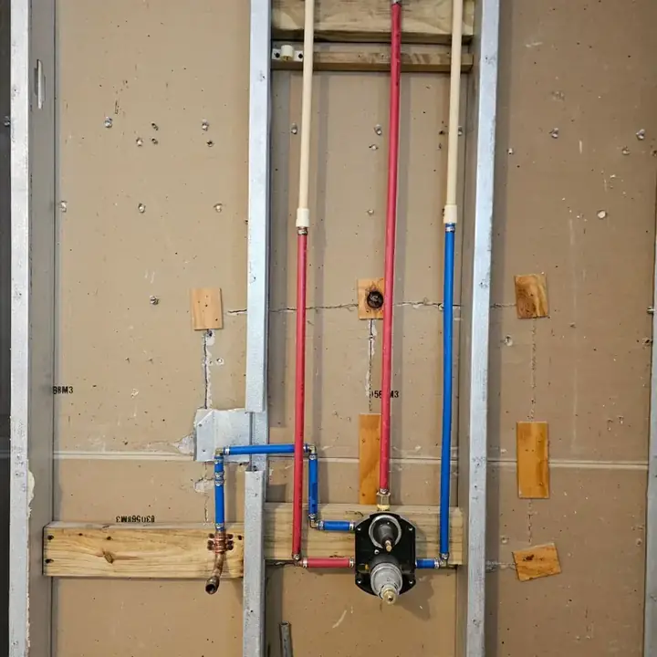 Shower valve and water lines roughed in on the wall framing