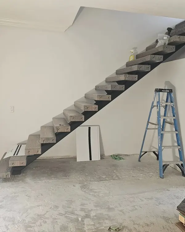 Floating staircase with thick wood treads on a steel stringer
