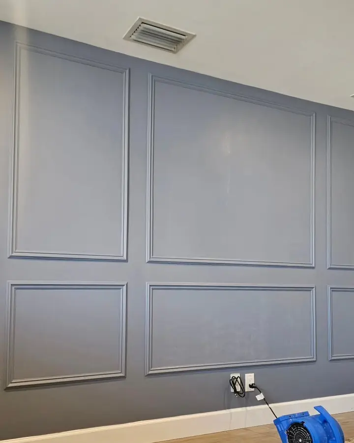 Picture-frame wall molding painted as a blue-grey accent wall
