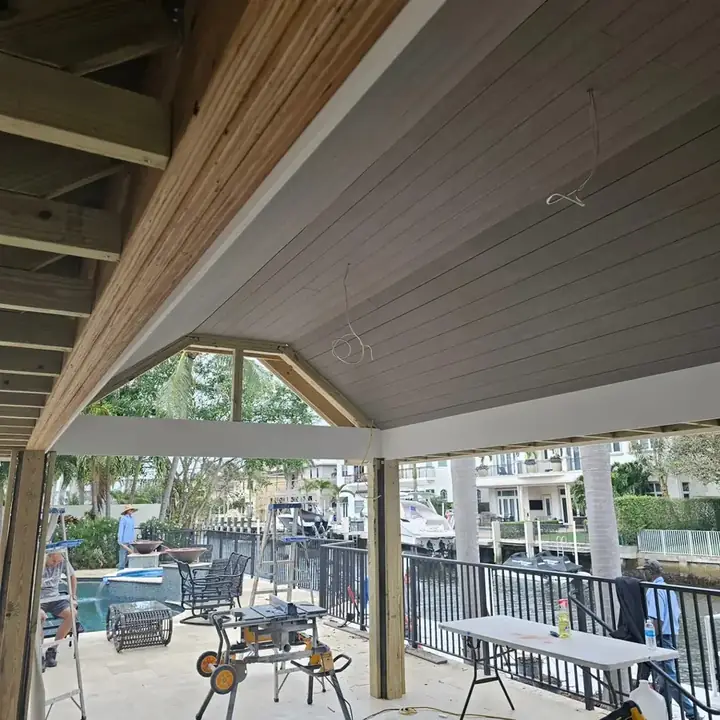 Ceiling boards going up under the pavilion roof framing