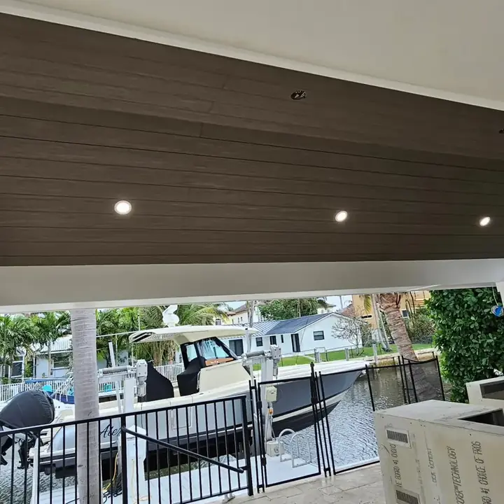 Finished pavilion ceiling with recessed lights over the outdoor kitchen by the water