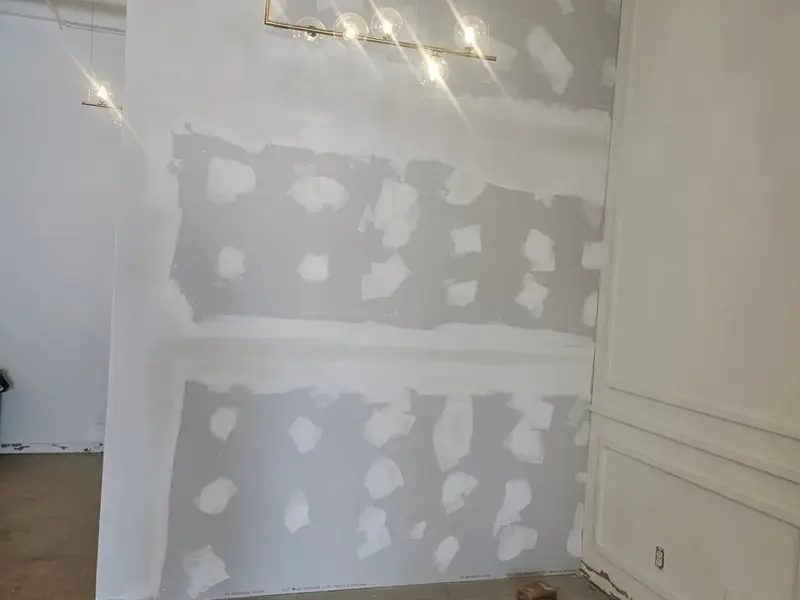 New drywall taped and patched, ready for paint