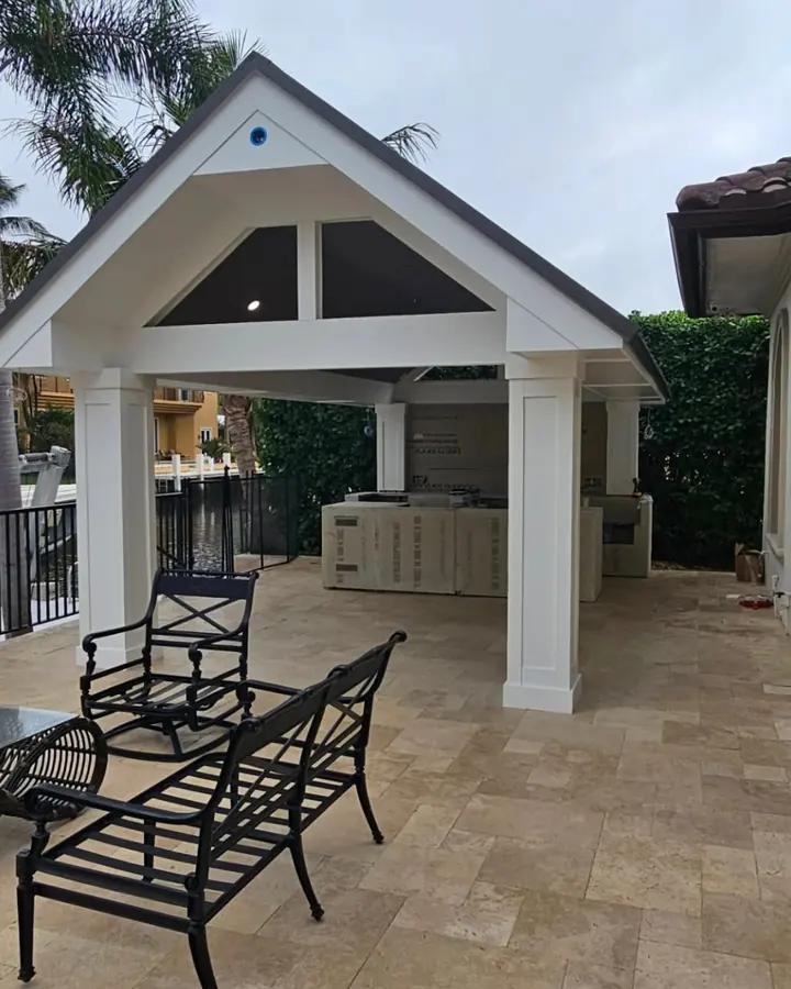 Outdoor pavilion with white columns over travertine pavers