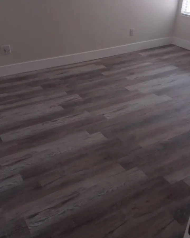 Empty room with new grey wood-look plank flooring