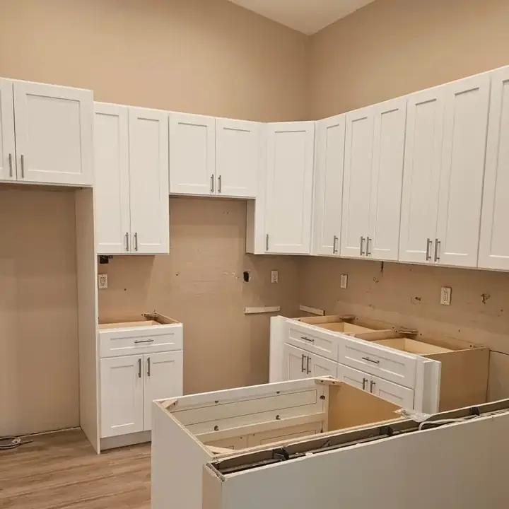 White shaker cabinets set on the walls and floor, before the countertops
